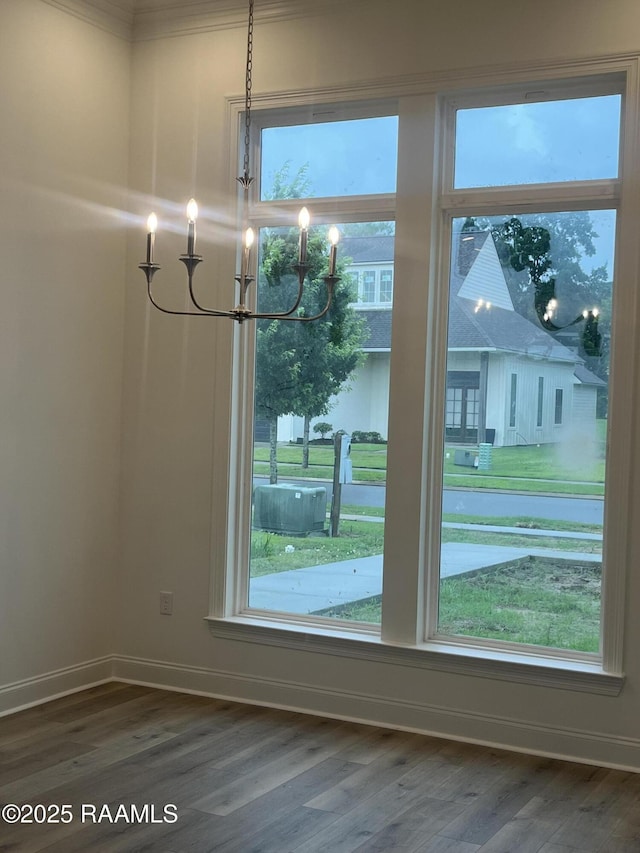 203 Redfern St, Lafayette, LA 70508 - unfurnished dining area with a chandelier, wood finished floors, baseboards, plenty of natural light, and ornamental molding