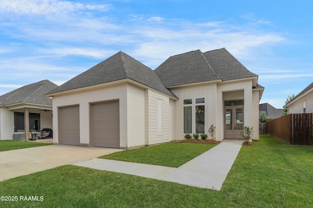 203 Redfern St, Lafayette, LA 70508 - view of front of property with a garage, french doors, concrete driveway, and roof with shingles
