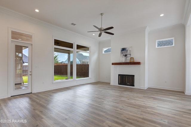 203 Redfern St, Lafayette, LA 70508 - unfurnished living room featuring ceiling fan, a fireplace, light wood finished floors, recessed lighting, and crown molding