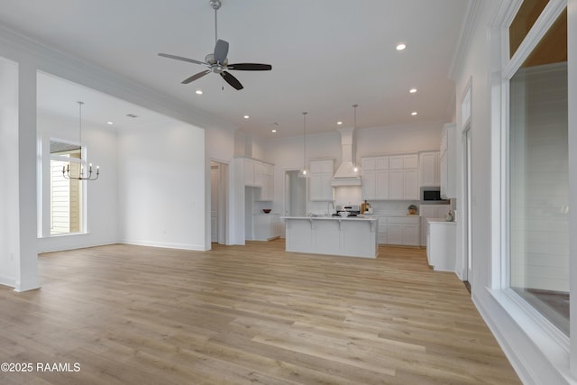 203 Redfern St, Lafayette, LA 70508 - unfurnished living room with a chandelier, ornamental molding, light wood-style floors, ceiling fan, and recessed lighting