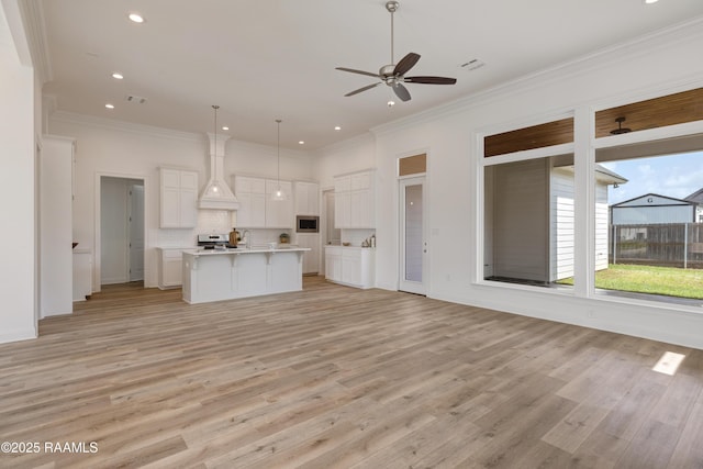 203 Redfern St, Lafayette, LA 70508 - kitchen with open floor plan, a ceiling fan, custom range hood, light wood-style floors, and recessed lighting