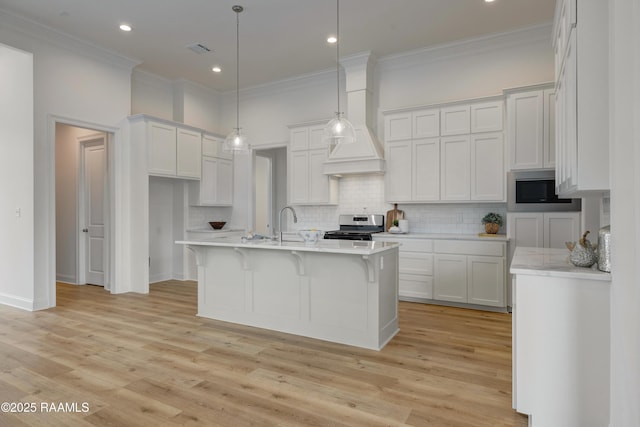 203 Redfern St, Lafayette, LA 70508 - kitchen with stainless steel appliances, crown molding, light countertops, decorative backsplash, and light wood-style floors