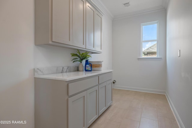 203 Redfern St, Lafayette, LA 70508 - laundry room featuring crown molding and light tile patterned flooring