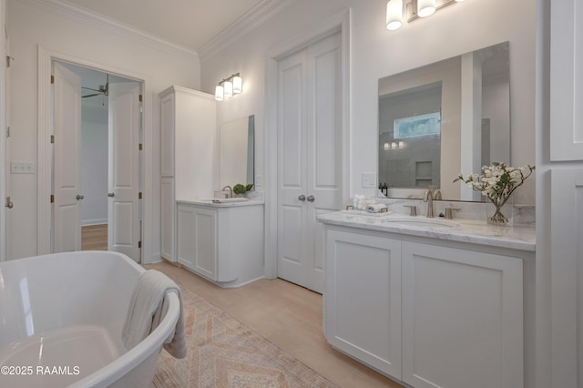 203 Redfern St, Lafayette, LA 70508 - full bathroom with two vanities, a soaking tub, and ornamental molding