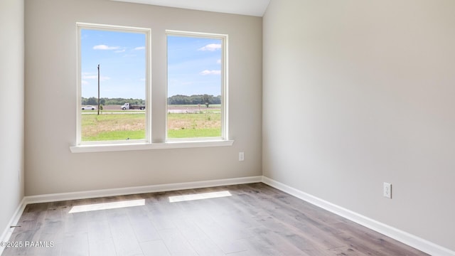 316 White Pine Dr, Lafayette, LA 70501 - spare room featuring plenty of natural light, wood finished floors, and baseboards