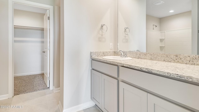 316 White Pine Dr, Lafayette, LA 70501 - bathroom featuring vanity, a walk in closet, tile patterned flooring, a shower, and baseboards