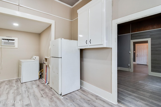 312 Hobson St, Lafayette, LA 70501 - kitchen with washer / dryer, freestanding refrigerator, a wall mounted AC, white cabinets, and light wood-style flooring