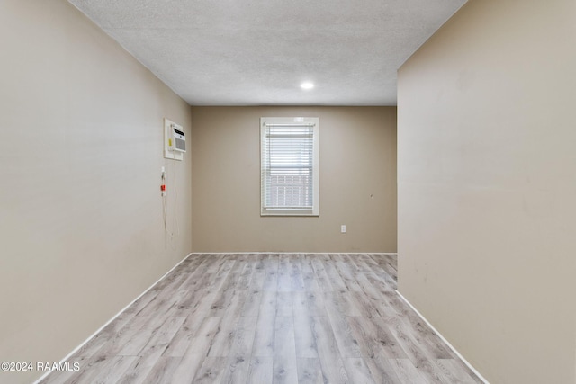 312 Hobson St, Lafayette, LA 70501 - spare room with light wood finished floors, a textured ceiling, and a wall mounted air conditioner