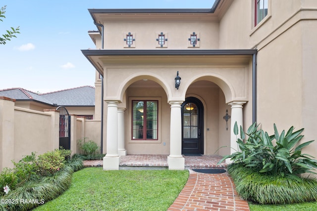 104 Avallach Dr, Lafayette, LA 70503 - entrance to property with stucco siding, covered porch, and a gate