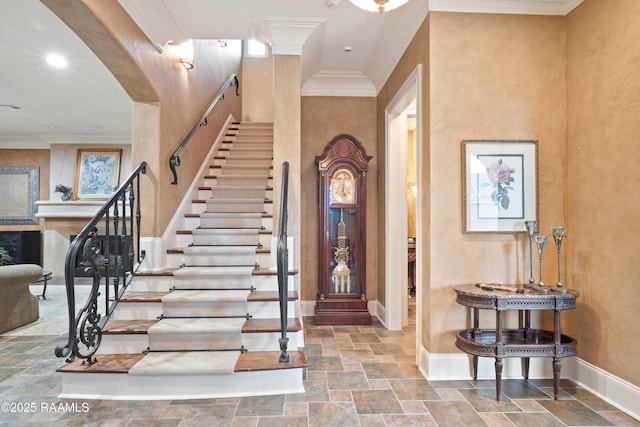 104 Avallach Dr, Lafayette, LA 70503 - foyer entrance with stone tile floors, baseboards, crown molding, a fireplace, and stairway