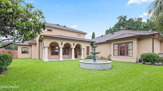 104 Avallach Dr, Lafayette, LA 70503 - back of house featuring stucco siding and a lawn