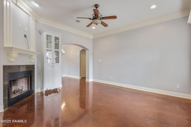103 Swallows Pass, Carencro, LA 70520 - unfurnished living room with a ceiling fan, a tiled fireplace, arched walkways, concrete flooring, and crown molding