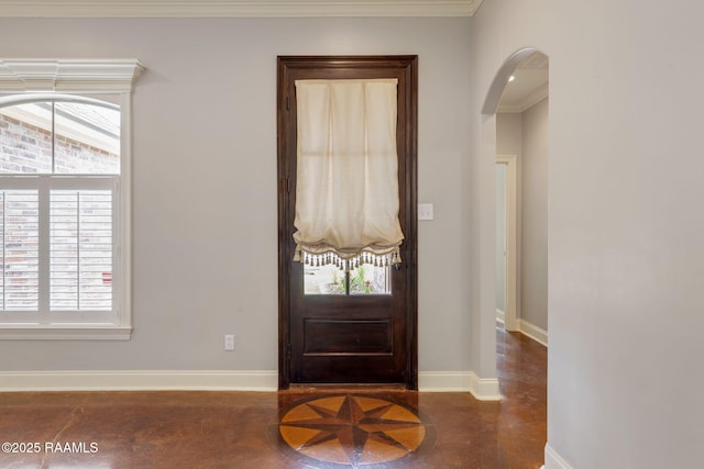 103 Swallows Pass, Carencro, LA 70520 - foyer featuring arched walkways, crown molding, concrete floors, healthy amount of natural light, and baseboards