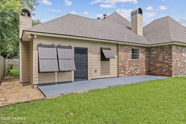 103 Swallows Pass, Carencro, LA 70520 - rear view of property with a chimney, brick siding, a shingled roof, and a patio