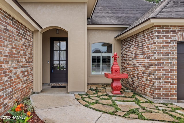 103 Swallows Pass, Carencro, LA 70520 - property entrance featuring brick siding, roof with shingles, and stucco siding