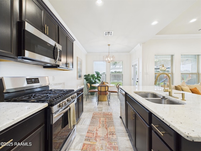 143 Melanie Rose Dr, Maurice, LA 70555 - kitchen with stainless steel appliances, a sink, crown molding, a chandelier, and pendant lighting