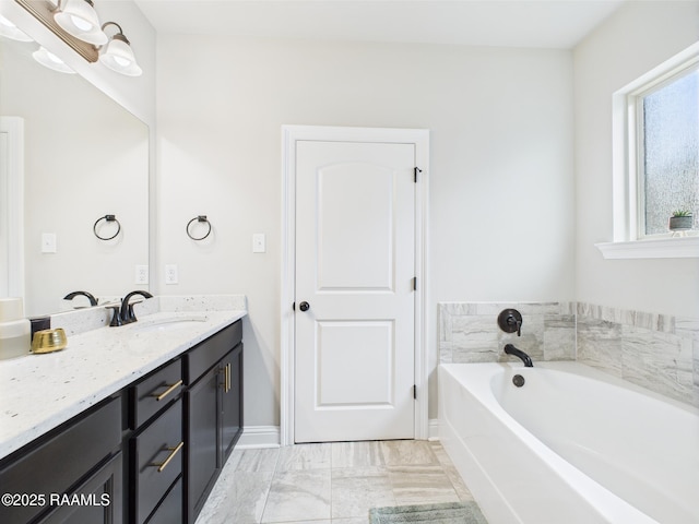 143 Melanie Rose Dr, Maurice, LA 70555 - full bathroom featuring vanity, a garden tub, and baseboards