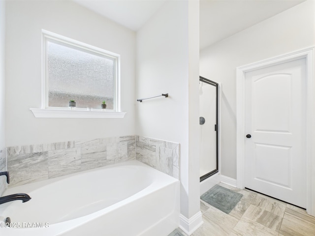 143 Melanie Rose Dr, Maurice, LA 70555 - full bath featuring a bath, a stall shower, and baseboards