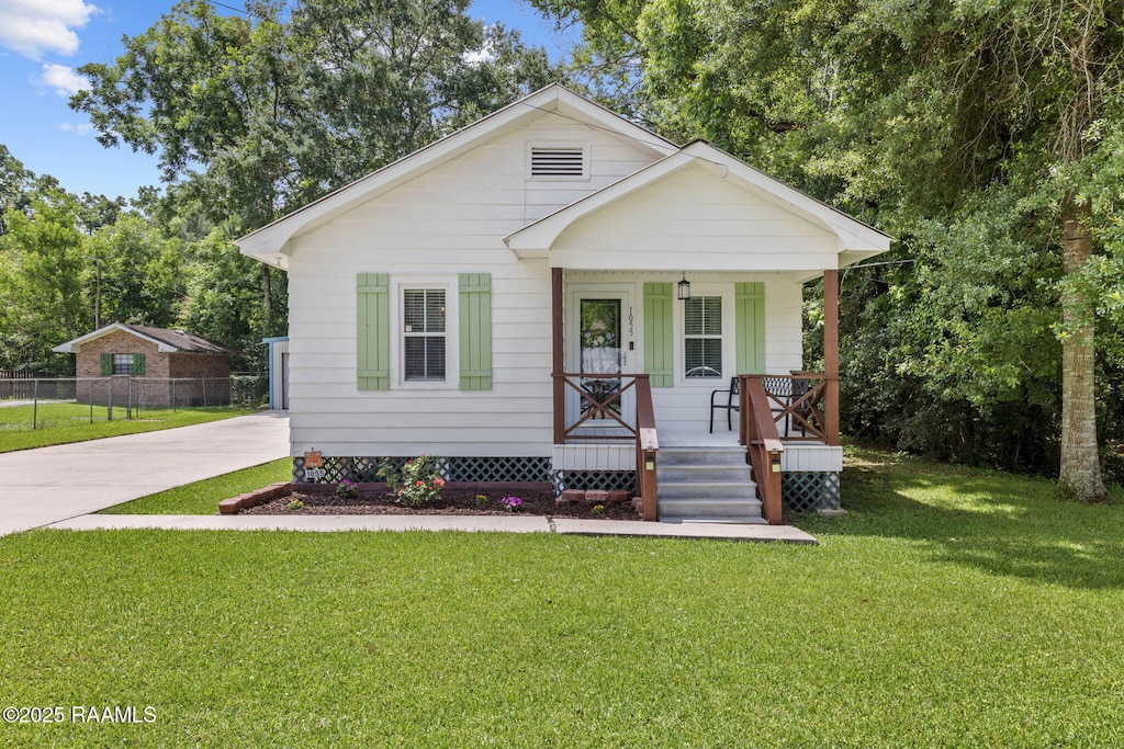 1055 Mason Rd, Arnaudville, LA 70512 - bungalow featuring a porch and concrete driveway