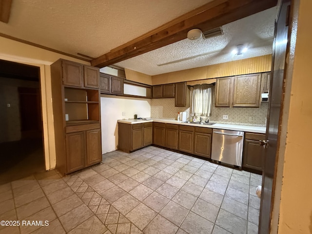 2015 Cummings St, Opelousas, LA 70570 - kitchen featuring dishwasher, a textured ceiling, a sink, light countertops, and light tile patterned flooring