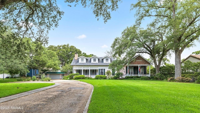1414 E Bayou Pkwy, Lafayette, LA 70508 - new england style home with a front lawn, a detached garage, driveway, and a chimney