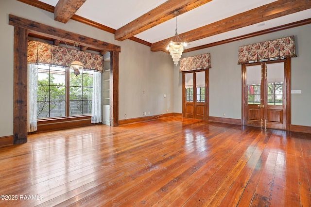 1414 E Bayou Pkwy, Lafayette, LA 70508 - unfurnished room featuring a chandelier, beamed ceiling, hardwood / wood-style floors, baseboards, and french doors