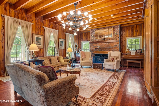 1414 E Bayou Pkwy, Lafayette, LA 70508 - living area featuring beam ceiling, wood walls, a chandelier, wood finished floors, and a fireplace