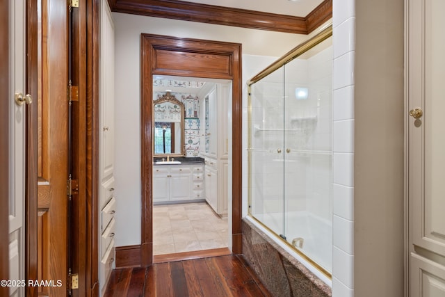 1414 E Bayou Pkwy, Lafayette, LA 70508 - bathroom featuring vanity, crown molding, hardwood / wood-style flooring, and tiled shower / bath combo
