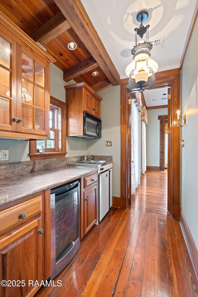 1414 E Bayou Pkwy, Lafayette, LA 70508 - kitchen featuring beverage cooler, baseboards, a sink, dark wood finished floors, and brown cabinets