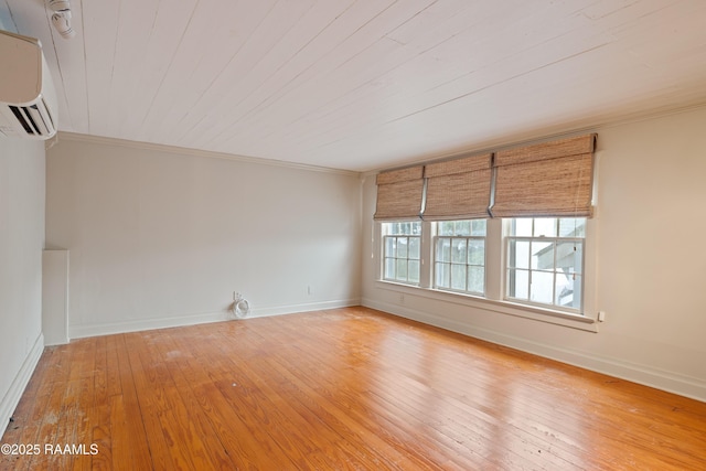 1414 E Bayou Pkwy, Lafayette, LA 70508 - spare room with a wall mounted air conditioner, light wood-type flooring, ornamental molding, baseboards, and wood ceiling