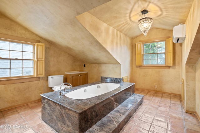 1414 E Bayou Pkwy, Lafayette, LA 70508 - bathroom with lofted ceiling, a bath, baseboards, a wall mounted air conditioner, and stone tile flooring