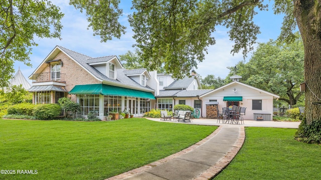 1414 E Bayou Pkwy, Lafayette, LA 70508 - back of property featuring a patio, a lawn, and roof with shingles