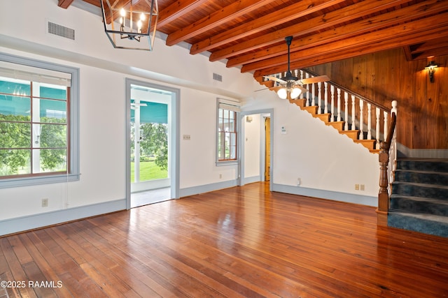 1414 E Bayou Pkwy, Lafayette, LA 70508 - unfurnished living room with stairs, a chandelier, wood-type flooring, wood ceiling with exposed beams, and baseboards