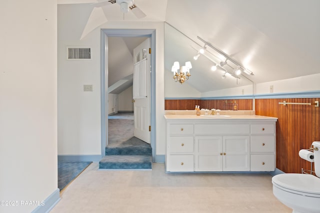 1414 E Bayou Pkwy, Lafayette, LA 70508 - bathroom with lofted ceiling, vanity, ceiling fan, toilet, and a chandelier