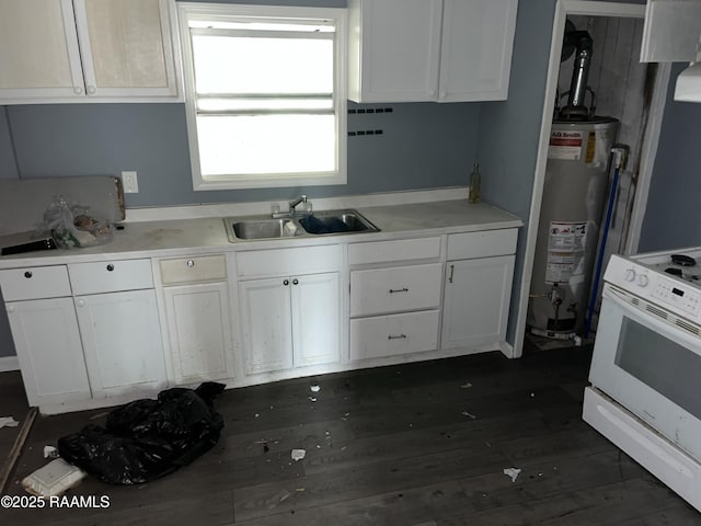 223 Lafayette St, Lafayette, LA 70501 - kitchen with white electric range oven, water heater, a sink, white cabinets, and dark wood-type flooring