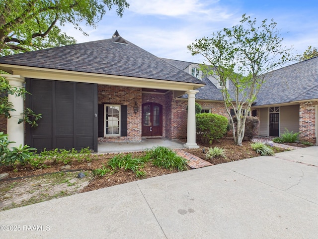 105 Oak Aly, Lafayette, LA 70508 - view of front of home featuring roof with shingles, brick siding, and covered porch