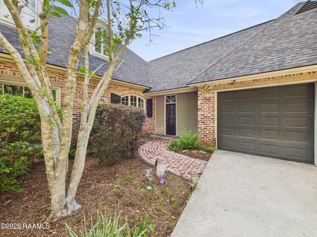 105 Oak Aly, Lafayette, LA 70508 - view of front facade featuring brick siding, a shingled roof, concrete driveway, and an attached garage