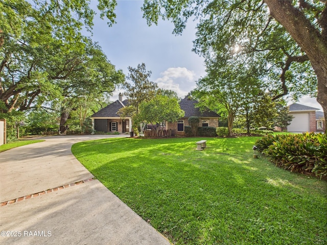 105 Oak Aly, Lafayette, LA 70508 - view of front of property with a front yard, driveway, brick siding, and roof with shingles