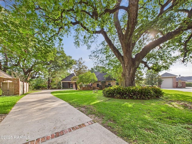 105 Oak Aly, Lafayette, LA 70508 - view of front of house featuring concrete driveway, a front yard, and a garage
