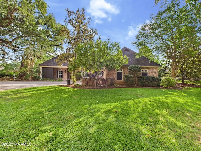 105 Oak Aly, Lafayette, LA 70508 - view of front of home with a front yard, brick siding, asphalt driveway, and a shingled roof