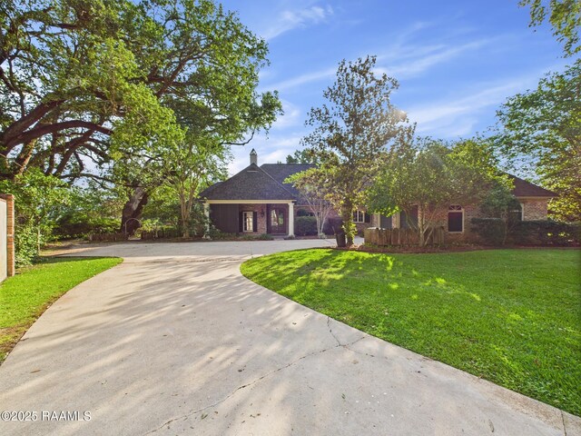 105 Oak Aly, Lafayette, LA 70508 - view of front facade featuring concrete driveway and a front yard