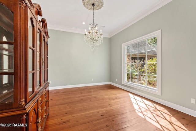 105 Oak Aly, Lafayette, LA 70508 - empty room with a chandelier, crown molding, baseboards, and light wood-style floors