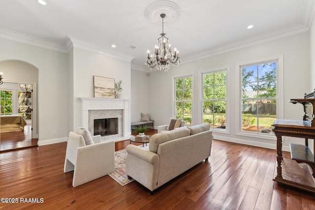 105 Oak Aly, Lafayette, LA 70508 - living room featuring a chandelier, dark wood-type flooring, a premium fireplace, crown molding, and baseboards