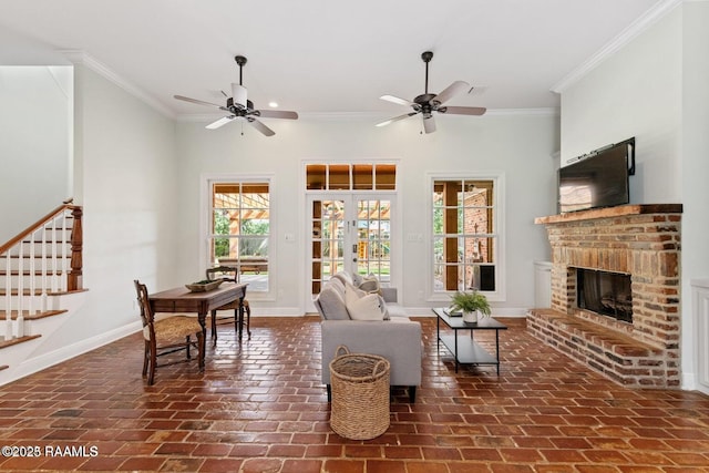 105 Oak Aly, Lafayette, LA 70508 - living area with ornamental molding, baseboards, a ceiling fan, stairway, and a brick fireplace