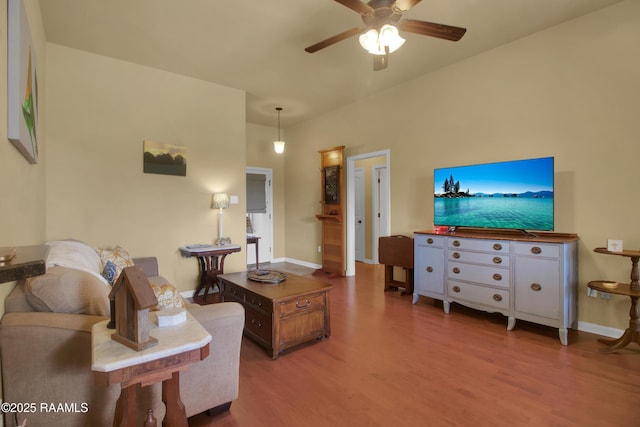 205 Broland Dr, Duson, LA 70529 - living area with wood finished floors, ceiling fan, and baseboards