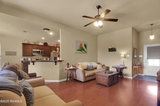 205 Broland Dr, Duson, LA 70529 - living area with dark wood finished floors, ceiling fan, and baseboards