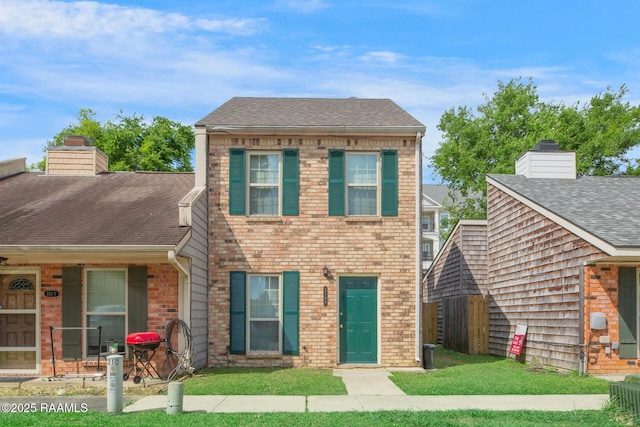 210 Long Plantation Blvd Unit U, Lafayette, LA 70508 - view of front facade featuring brick siding, roof with shingles, and a chimney