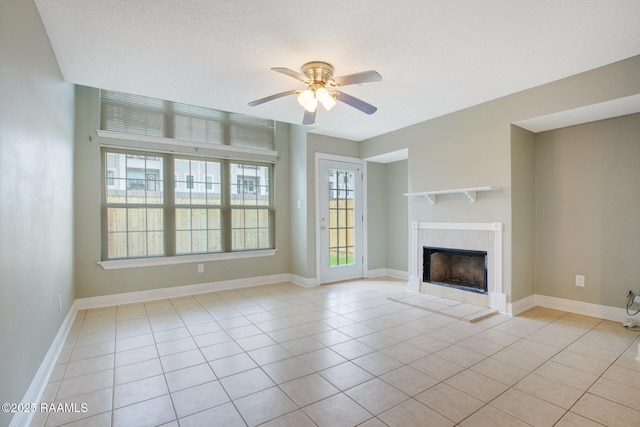 210 Long Plantation Blvd Unit U, Lafayette, LA 70508 - unfurnished living room featuring light tile patterned flooring, a ceiling fan, a tiled fireplace, and baseboards