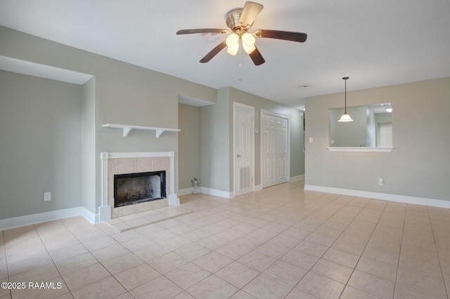 210 Long Plantation Blvd Unit U, Lafayette, LA 70508 - unfurnished living room with a ceiling fan, light tile patterned floors, a tile fireplace, and baseboards