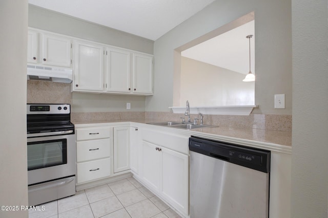 210 Long Plantation Blvd Unit U, Lafayette, LA 70508 - kitchen featuring appliances with stainless steel finishes, under cabinet range hood, a sink, light tile patterned floors, and white cabinetry